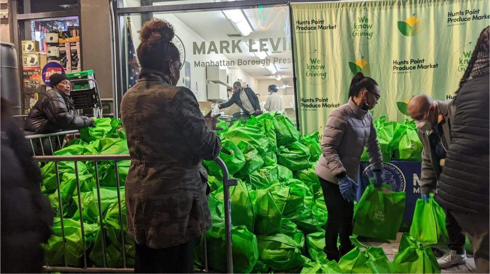 Volunteers preparing bags of produce to distribute to community members